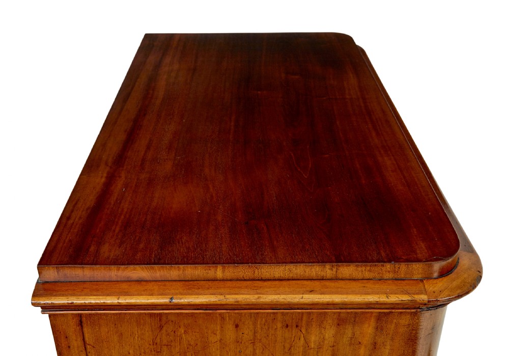 A nineteenth-century Swedish mahogany chest of drawers featuring five stacked drawers with book-matched veneer and brass keyhole escutcheons. View X