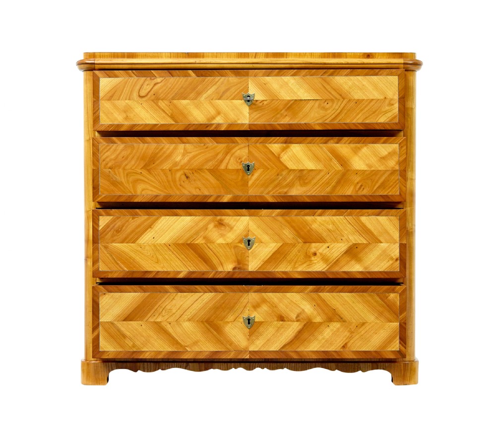 A mid-nineteenth-century Scandinavian chest of drawers crafted from inlaid elm wood with chevron patterns across four drawers and brass shield keyhole escutcheons. View III