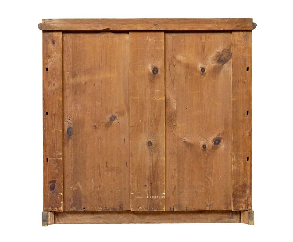 A mid-nineteenth-century Scandinavian chest of drawers crafted from inlaid elm wood with chevron patterns across four drawers and brass shield keyhole escutcheons. View VI
