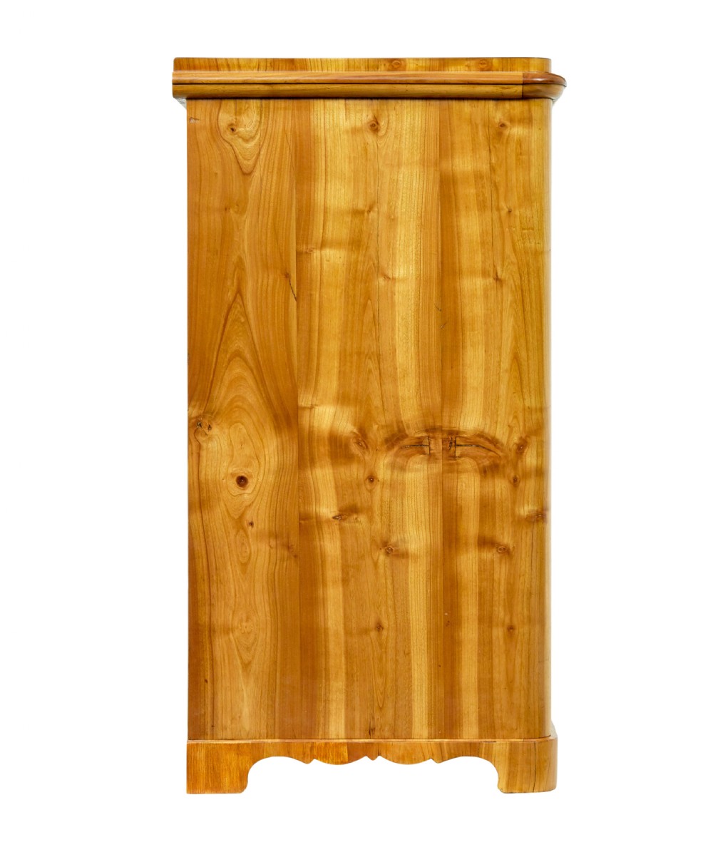 A mid-nineteenth-century Scandinavian chest of drawers crafted from inlaid elm wood with chevron patterns across four drawers and brass shield keyhole escutcheons. View VII