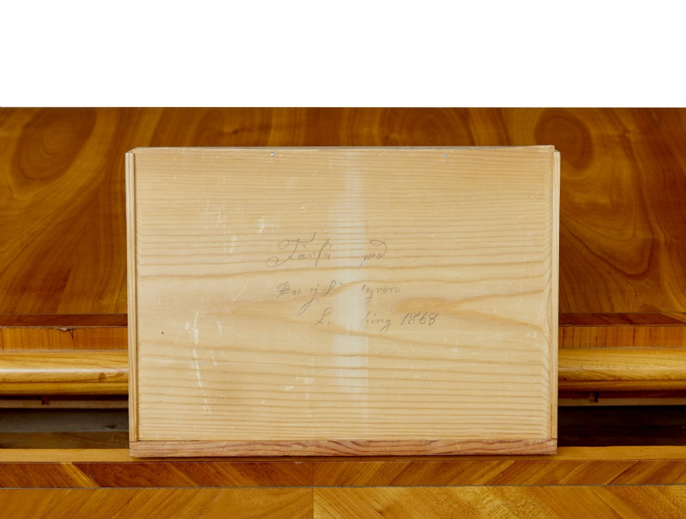 A mid-nineteenth-century Scandinavian chest of drawers crafted from inlaid elm wood with chevron patterns across four drawers and brass shield keyhole escutcheons. View XIII