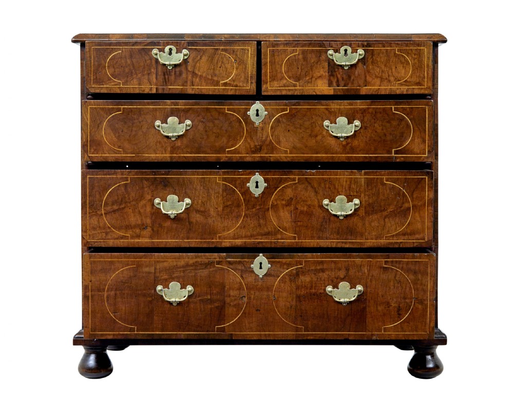 A 17th-century William and Mary walnut chest of drawers with decorative line inlay, brass drop handles, and turned bun feet. View III