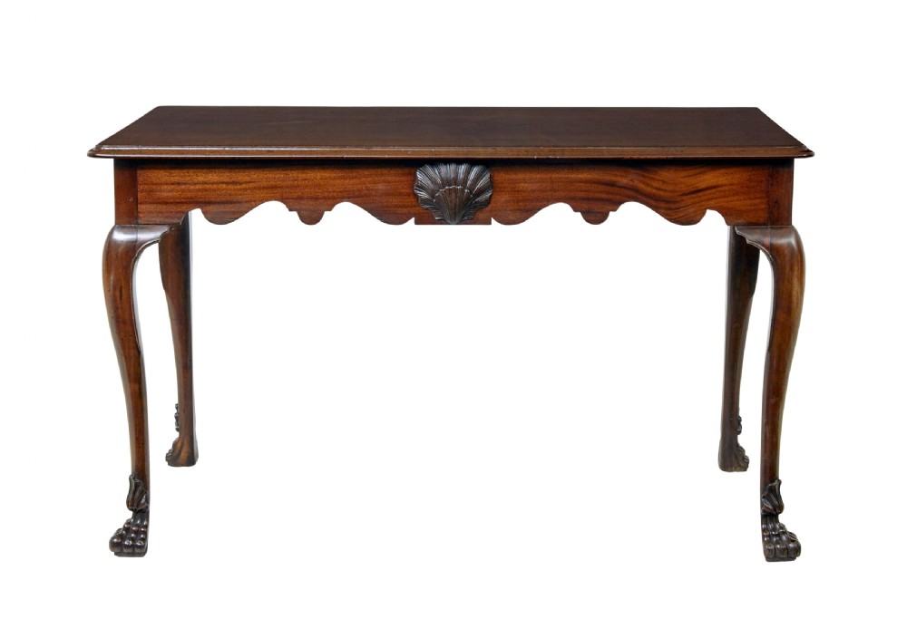 An early nineteenth-century Irish mahogany serving table with a carved central shell motif, scalloped frieze, cabriole legs, and carved feet. View II