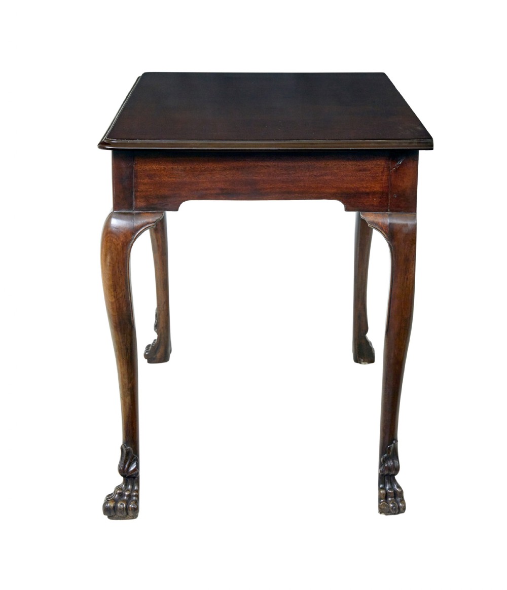 An early nineteenth-century Irish mahogany serving table with a carved central shell motif, scalloped frieze, cabriole legs, and carved feet. View III