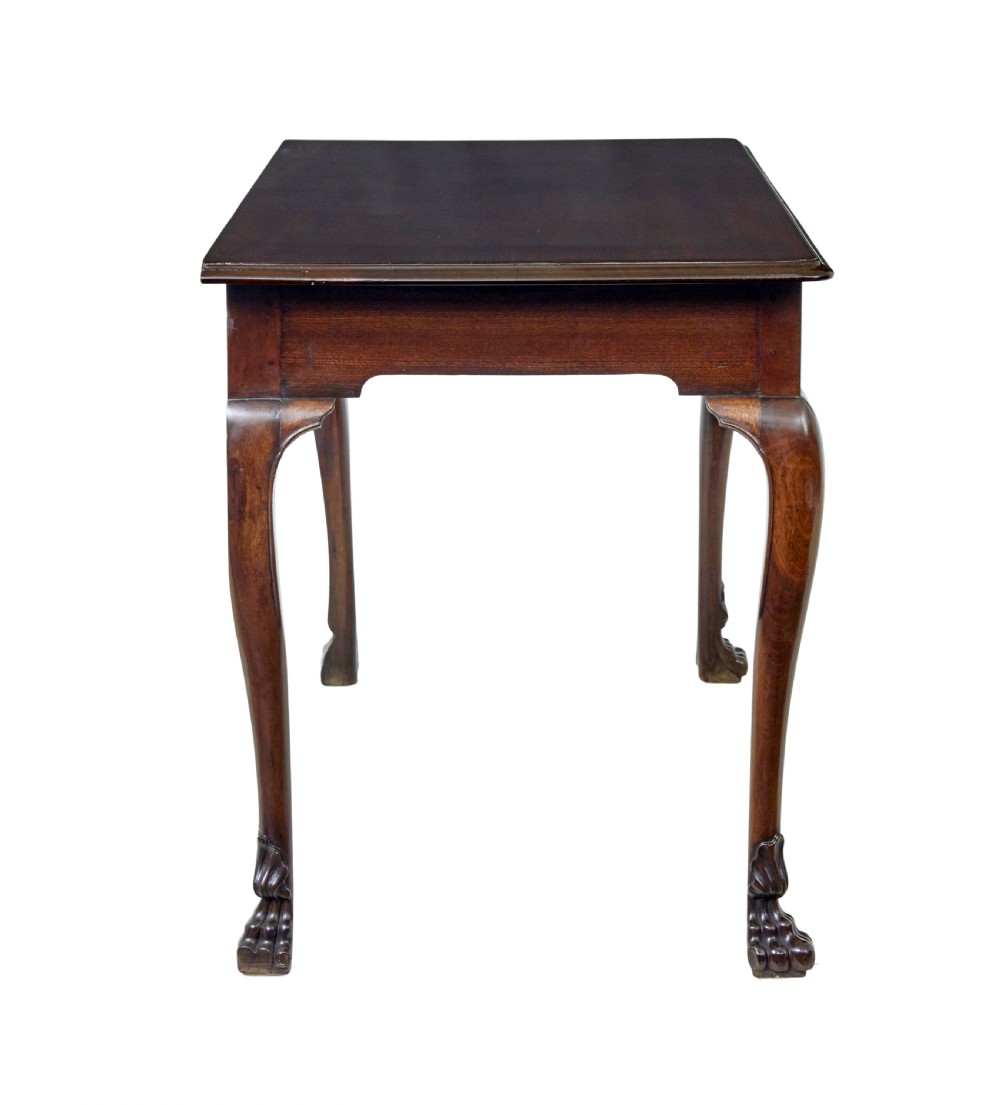 An early nineteenth-century Irish mahogany serving table with a carved central shell motif, scalloped frieze, cabriole legs, and carved feet. View V