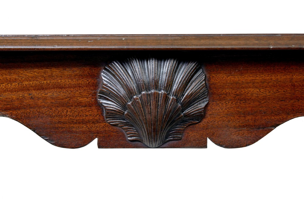 An early nineteenth-century Irish mahogany serving table with a carved central shell motif, scalloped frieze, cabriole legs, and carved feet. View VIII
