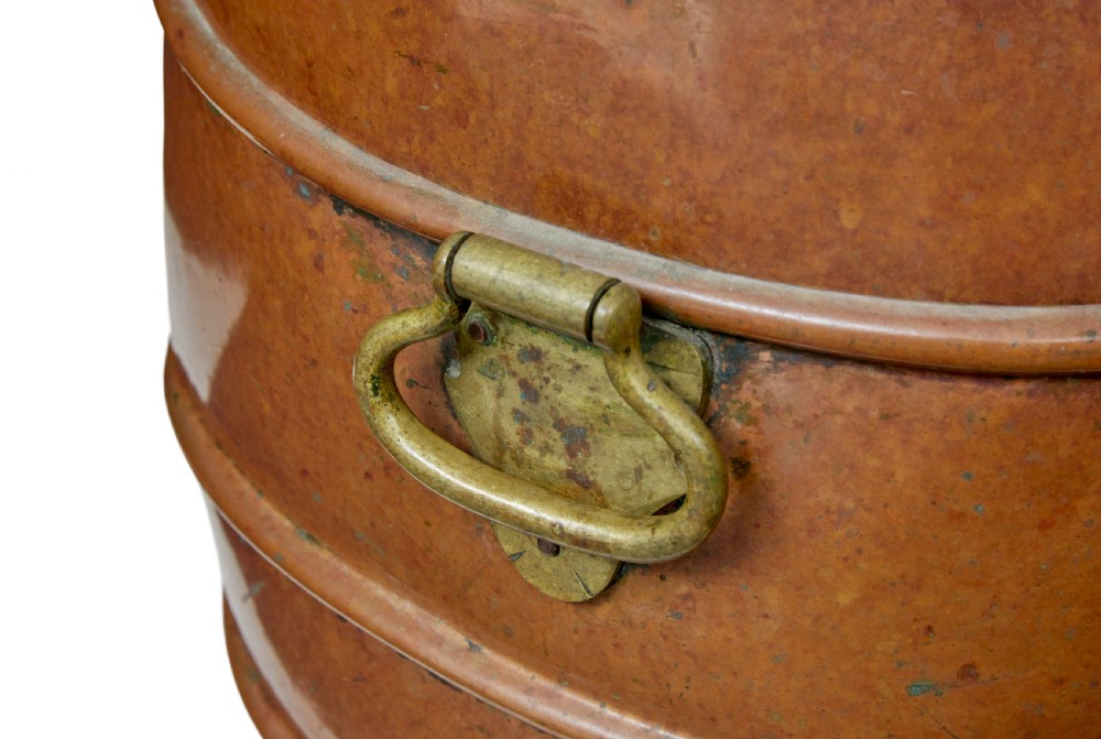 A 19th-century copper water barrel with horizontal raised bands, cast brass drop handles, a flared base, and a fitted copper lid with a brass knob. View VIII