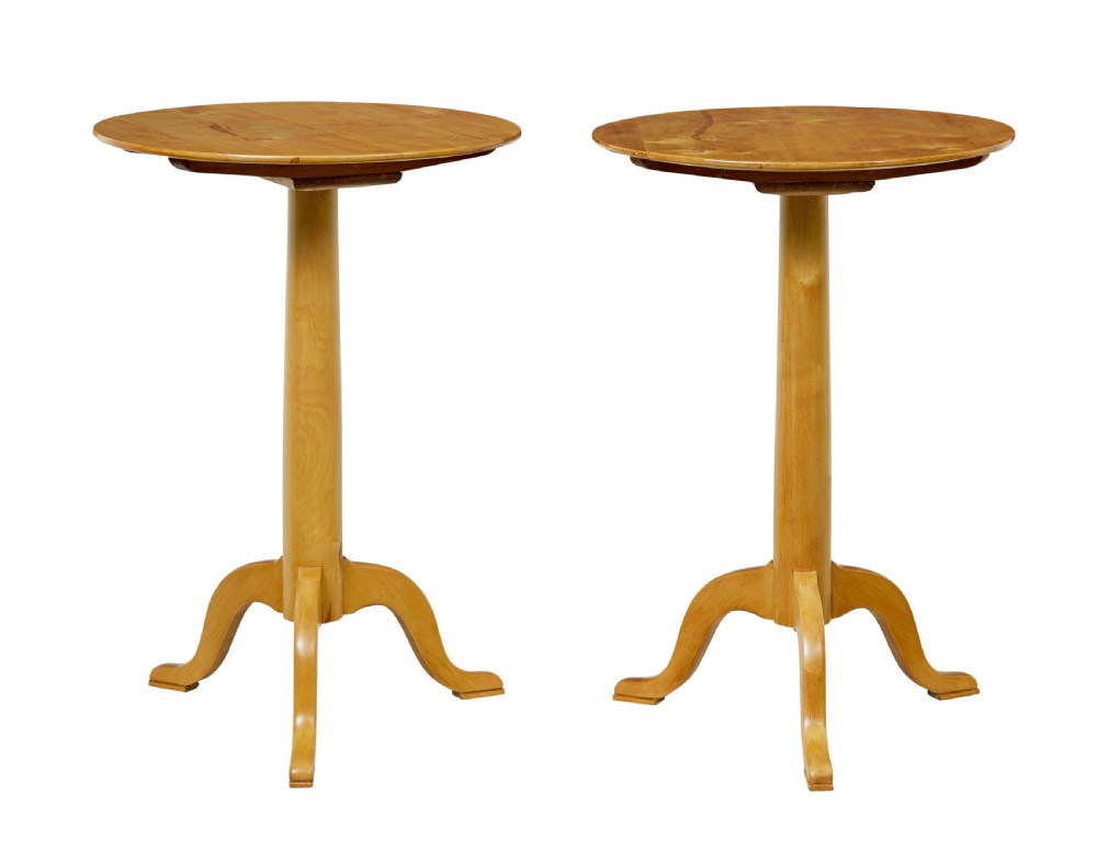 A pair of 19th-century Swedish light birch side tables featuring circular tops supported by turned central pedestals and tripod legs.