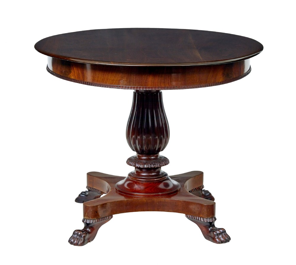 A nineteenth-century mahogany oval centre table featuring a fluted pedestal stem and carved paw feet on a concave quadripartite base. View II
