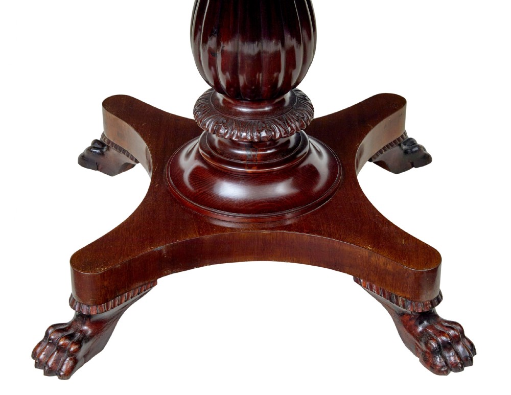 A nineteenth-century mahogany oval centre table featuring a fluted pedestal stem and carved paw feet on a concave quadripartite base. View IV
