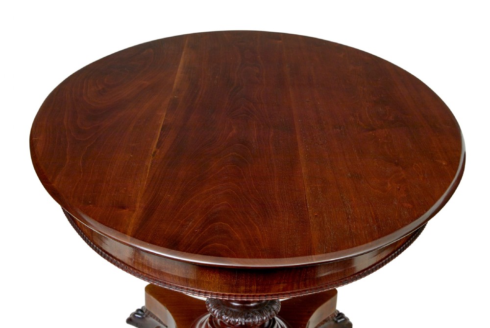 A nineteenth-century mahogany oval centre table featuring a fluted pedestal stem and carved paw feet on a concave quadripartite base. View V