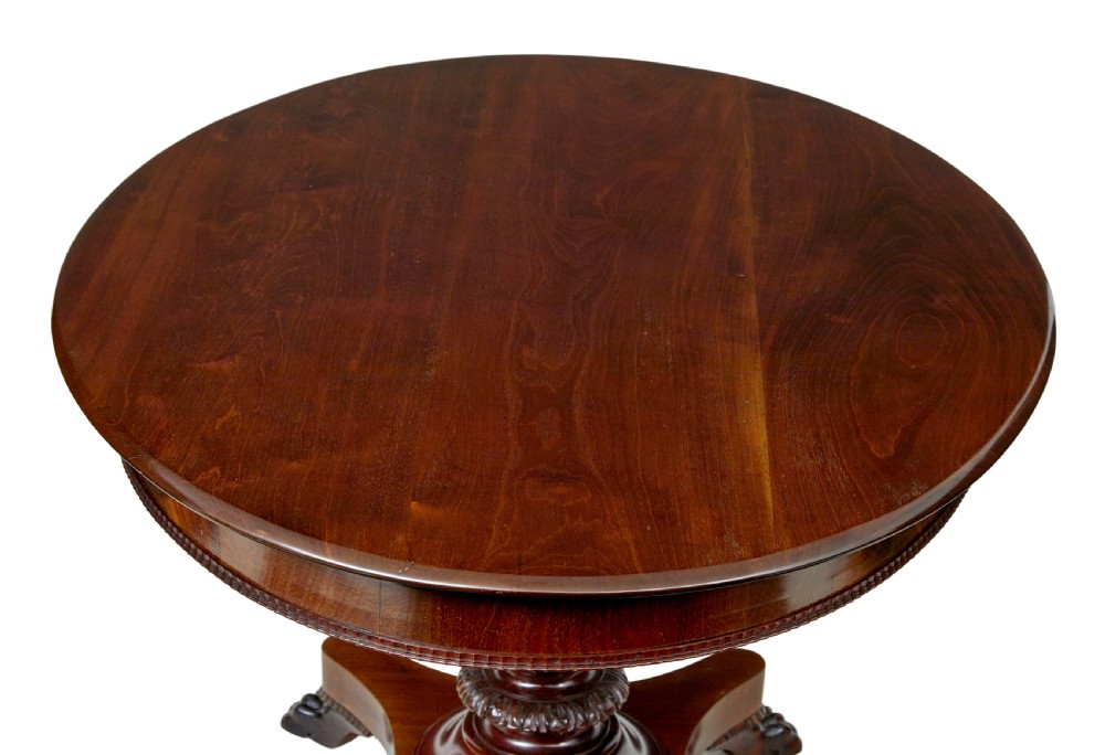 A nineteenth-century mahogany oval centre table featuring a fluted pedestal stem and carved paw feet on a concave quadripartite base. View VI