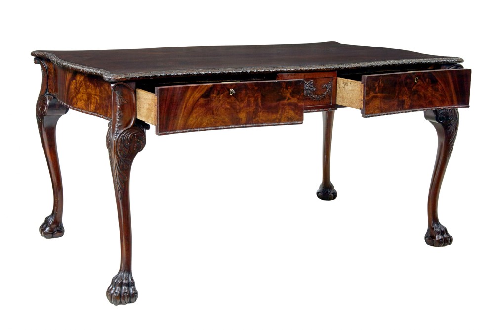 A mid-19th-century mahogany writing desk in the Chippendale style featuring cabriole legs ending in ball and claw feet, with carved knee details and frieze drawers. View II