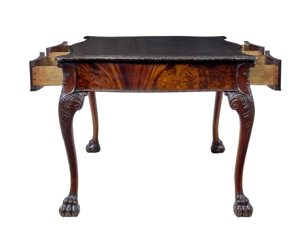 A mid-19th-century mahogany writing desk in the Chippendale style featuring cabriole legs ending in ball and claw feet, with carved knee details and frieze drawers. View IV
