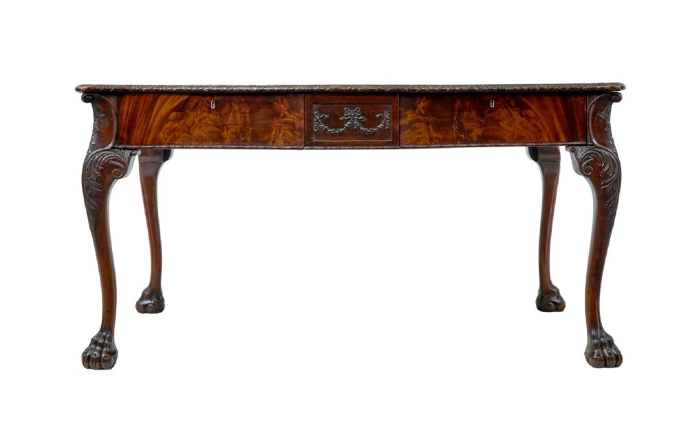 A mid-19th-century mahogany writing desk in the Chippendale style featuring cabriole legs ending in ball and claw feet, with carved knee details and frieze drawers. View V
