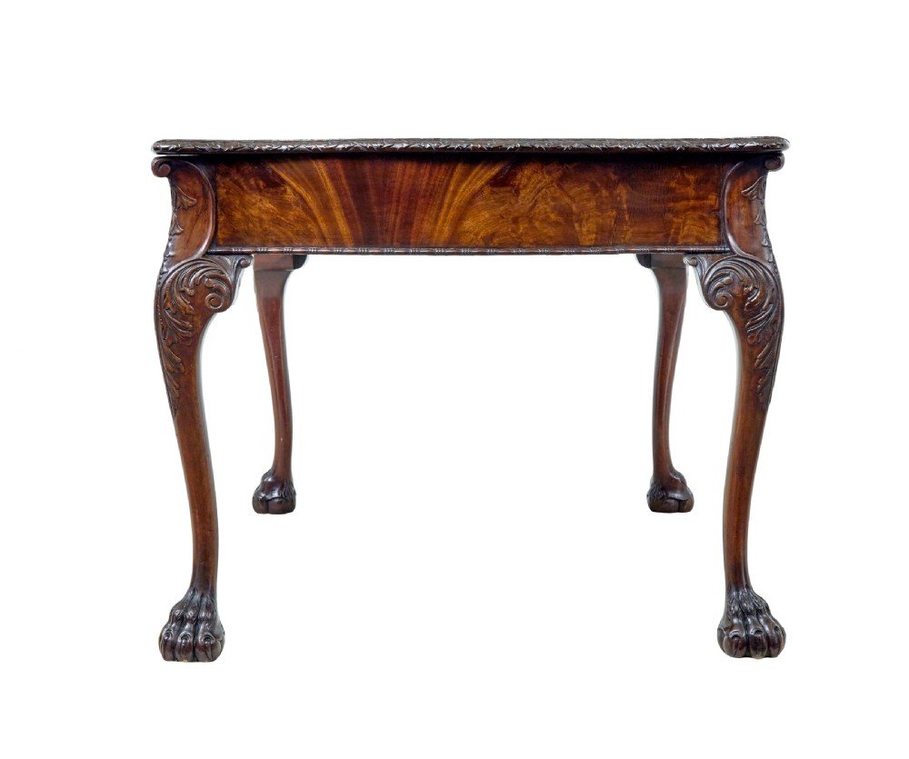 A mid-19th-century mahogany writing desk in the Chippendale style featuring cabriole legs ending in ball and claw feet, with carved knee details and frieze drawers. View VI