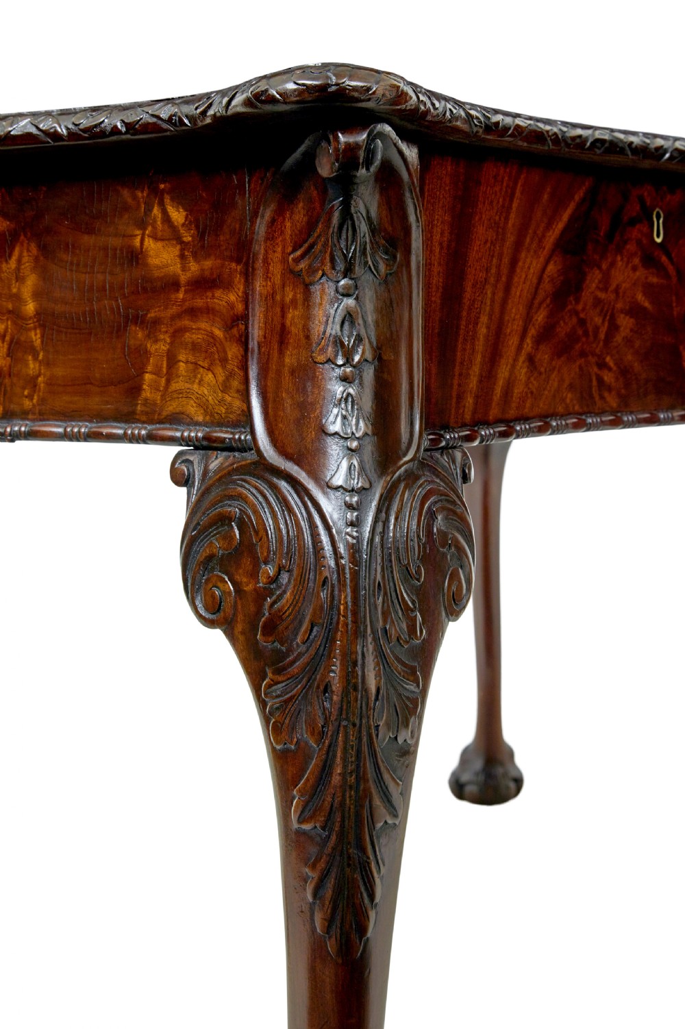 A mid-19th-century mahogany writing desk in the Chippendale style featuring cabriole legs ending in ball and claw feet, with carved knee details and frieze drawers. View X