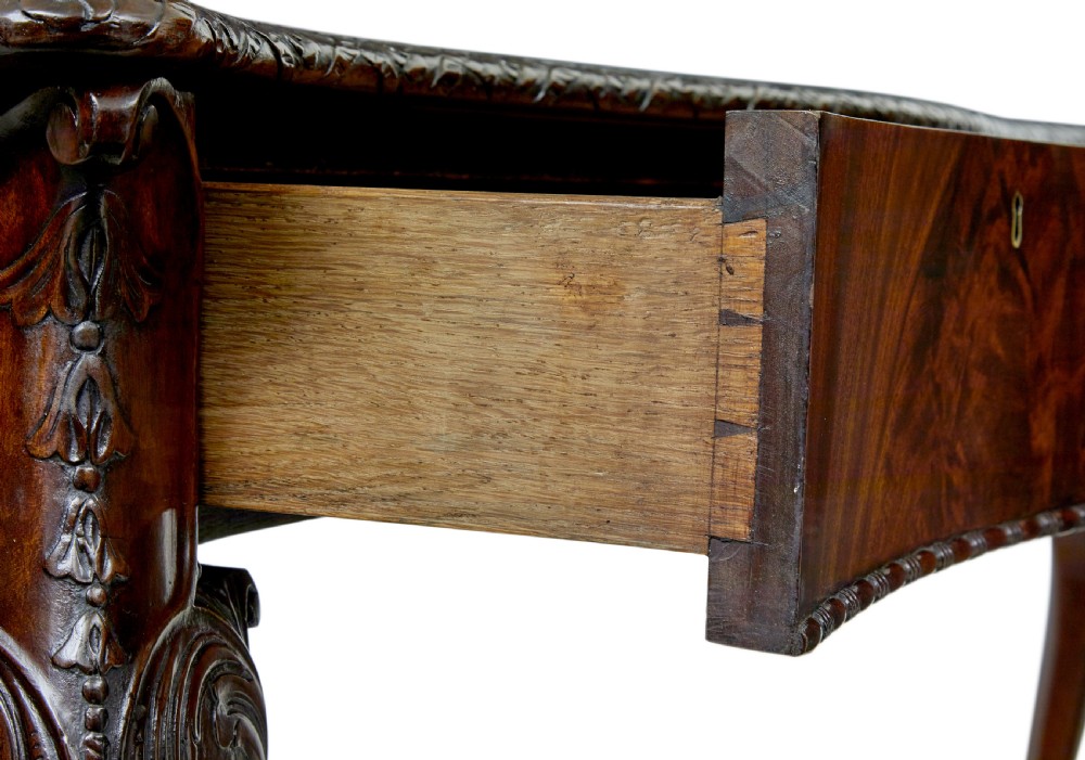 A mid-19th-century mahogany writing desk in the Chippendale style featuring cabriole legs ending in ball and claw feet, with carved knee details and frieze drawers. View XI