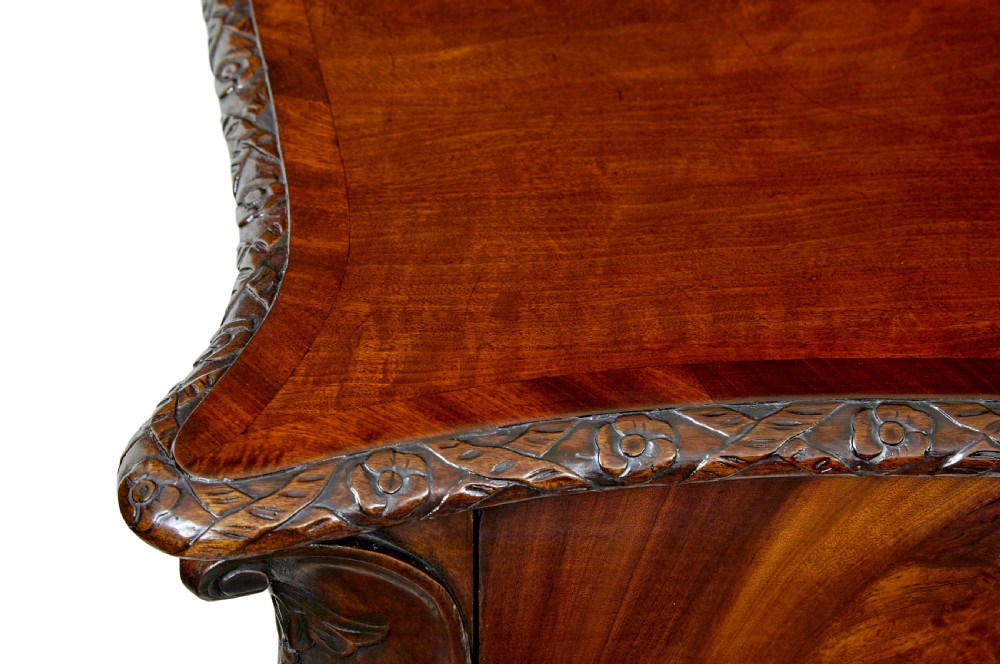 A mid-19th-century mahogany writing desk in the Chippendale style featuring cabriole legs ending in ball and claw feet, with carved knee details and frieze drawers. View XII