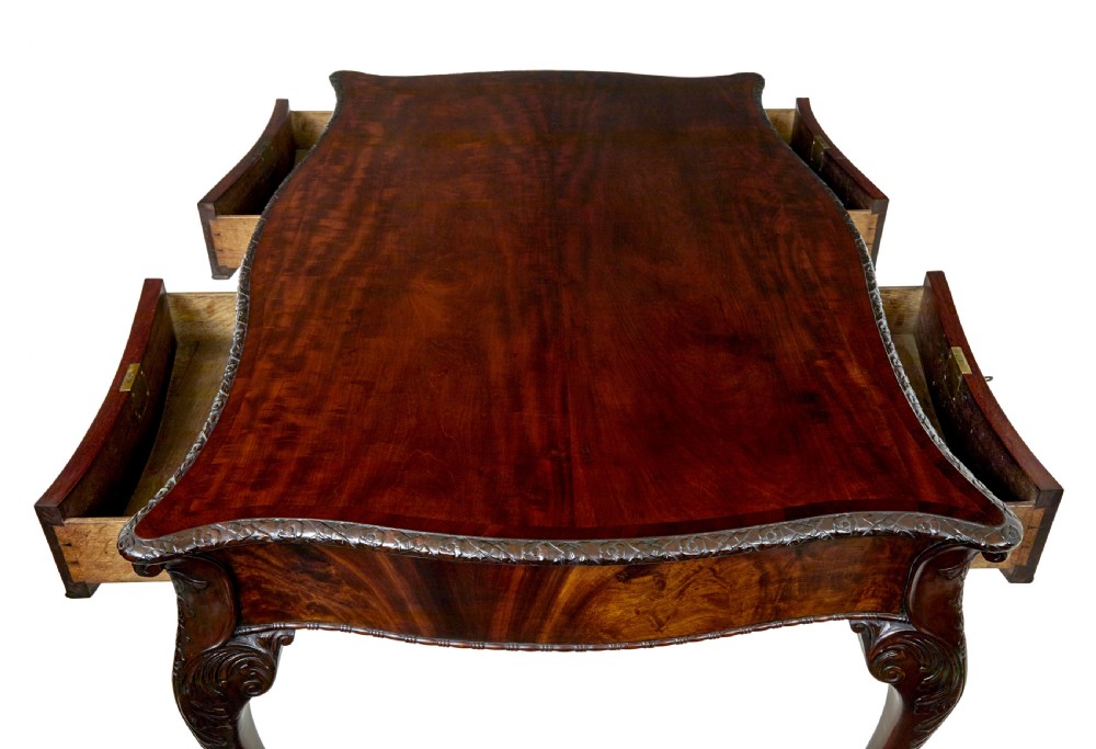 A mid-19th-century mahogany writing desk in the Chippendale style featuring cabriole legs ending in ball and claw feet, with carved knee details and frieze drawers. View XIII