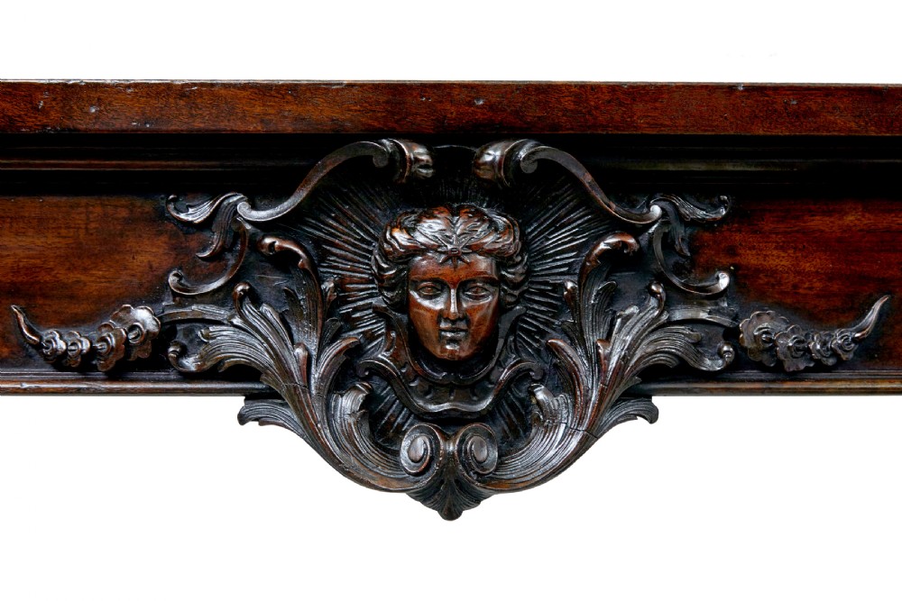 A 19th-century dark mahogany serving table featuring carved cabriole legs, claw feet, and a carved central apron mask. View VII