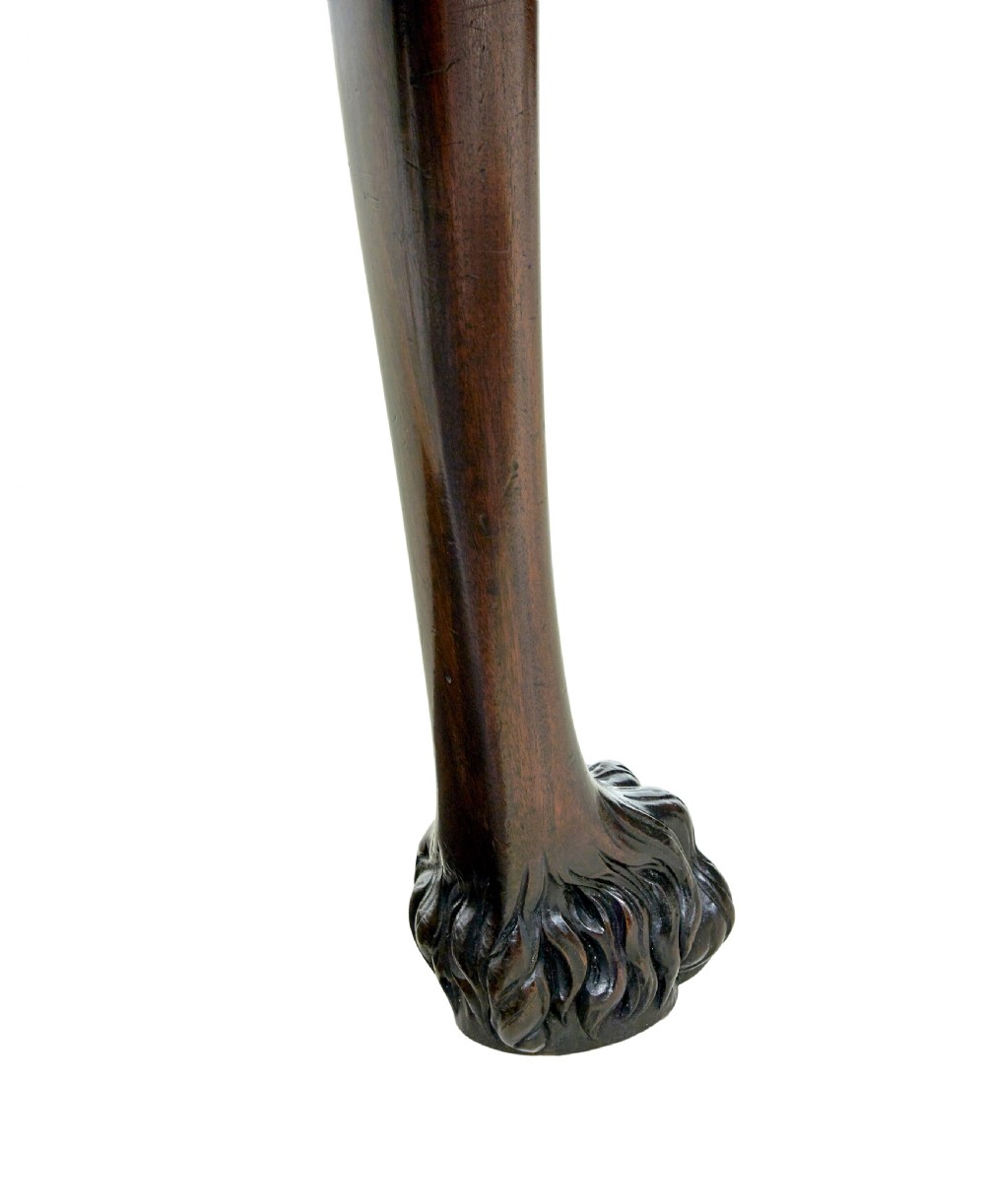 A 19th-century dark mahogany serving table featuring carved cabriole legs, claw feet, and a carved central apron mask. View IX