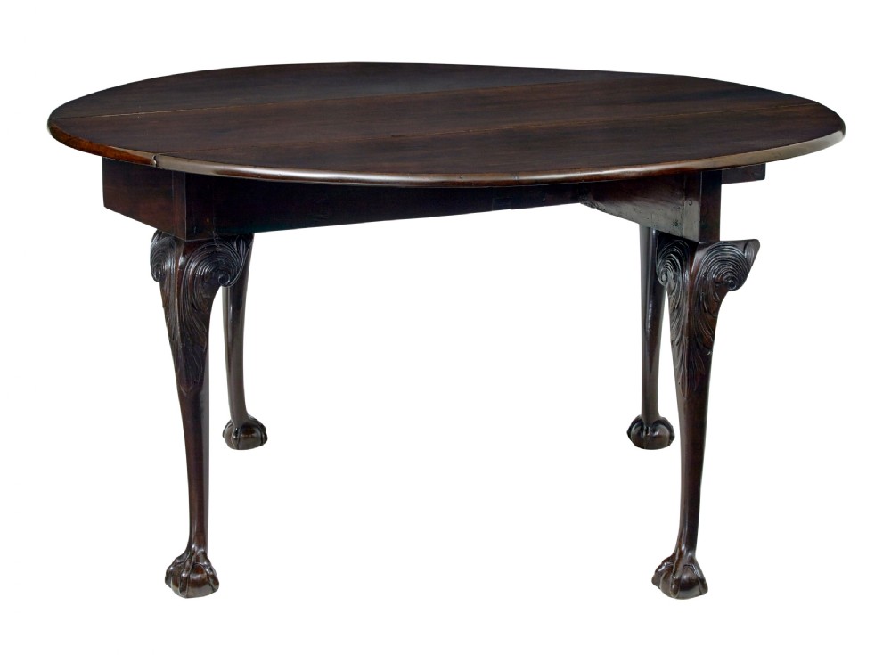 An 18th-century mahogany drop-leaf table featuring hinged oval flaps, cabriole legs with carved acanthus knees, and ball-and-claw feet. View II