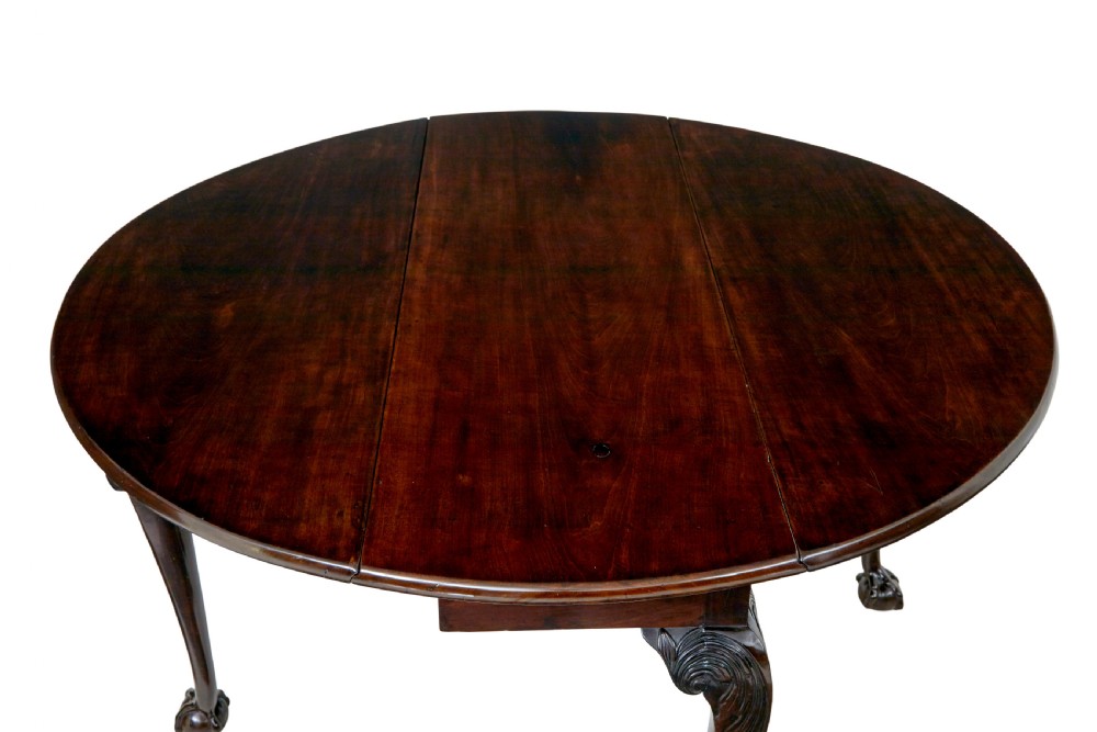 An 18th-century mahogany drop-leaf table featuring hinged oval flaps, cabriole legs with carved acanthus knees, and ball-and-claw feet. View IV