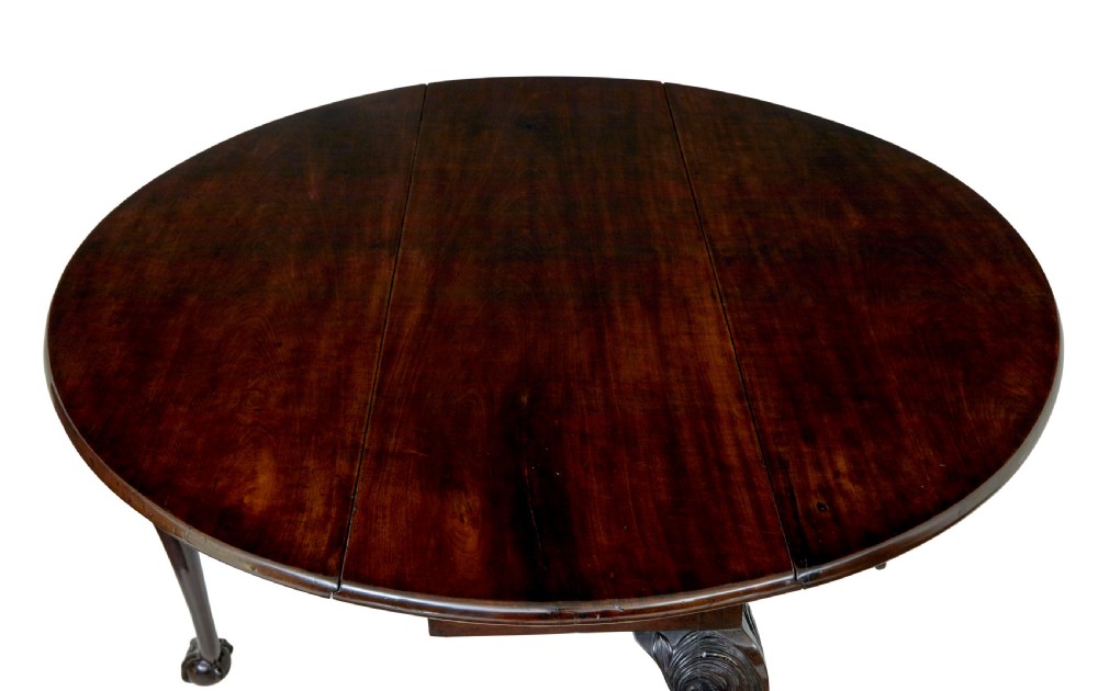 An 18th-century mahogany drop-leaf table featuring hinged oval flaps, cabriole legs with carved acanthus knees, and ball-and-claw feet. View VI