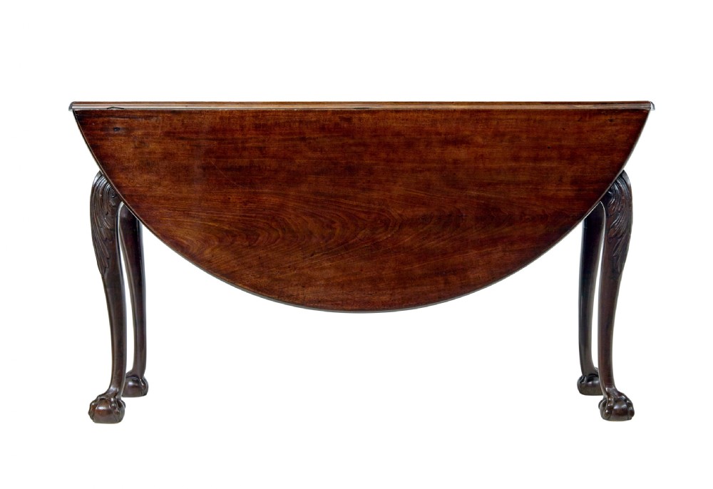 An 18th-century mahogany drop-leaf table featuring hinged oval flaps, cabriole legs with carved acanthus knees, and ball-and-claw feet. View VII