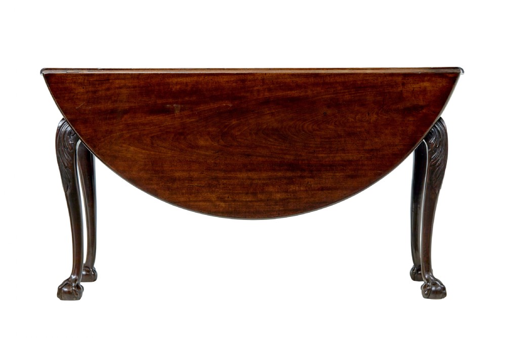An 18th-century mahogany drop-leaf table featuring hinged oval flaps, cabriole legs with carved acanthus knees, and ball-and-claw feet. View IX