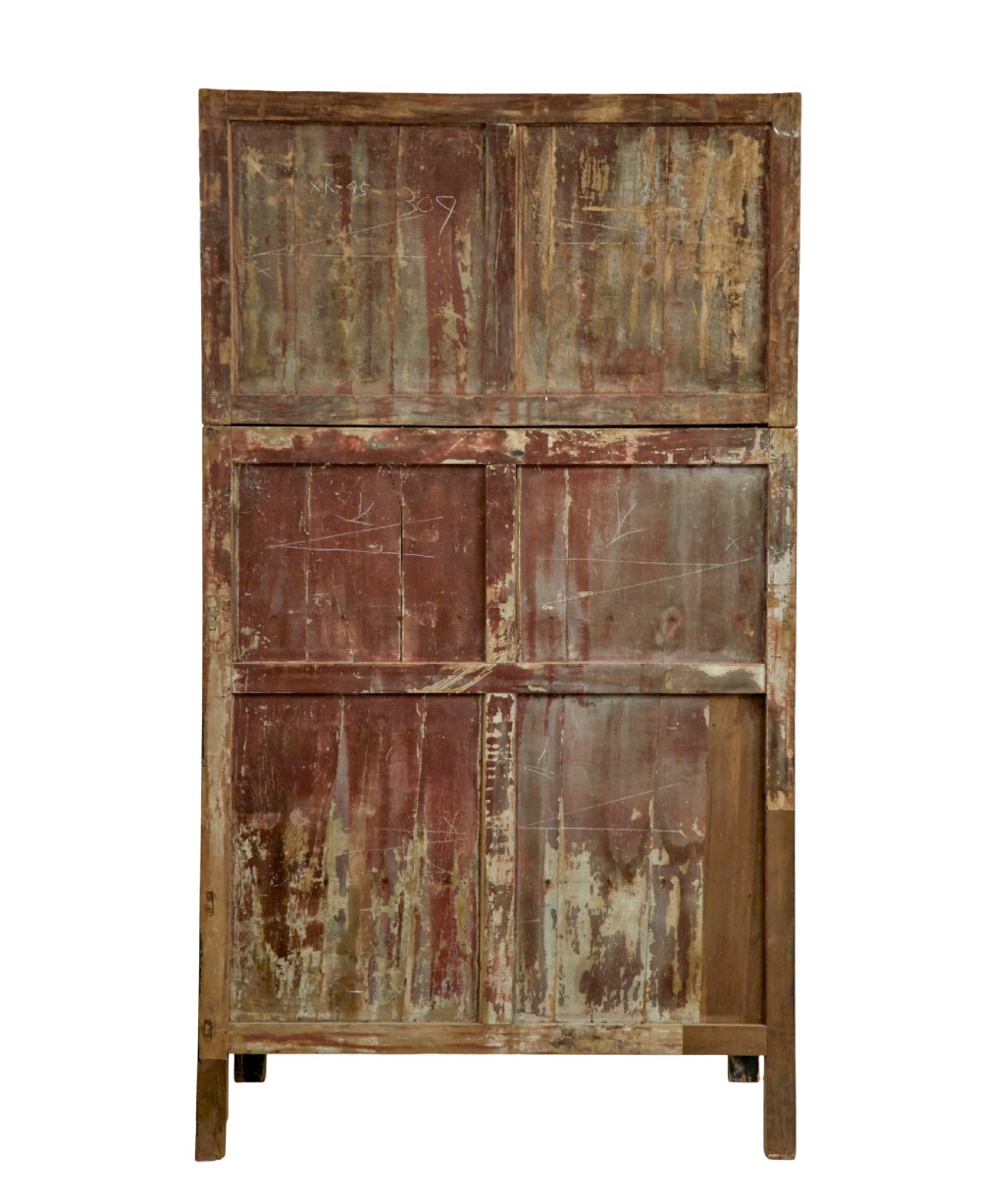 A pair of tall 19th-century black lacquered Chinese compound cabinets featuring circular brass lockplates and carved apron bases. View V