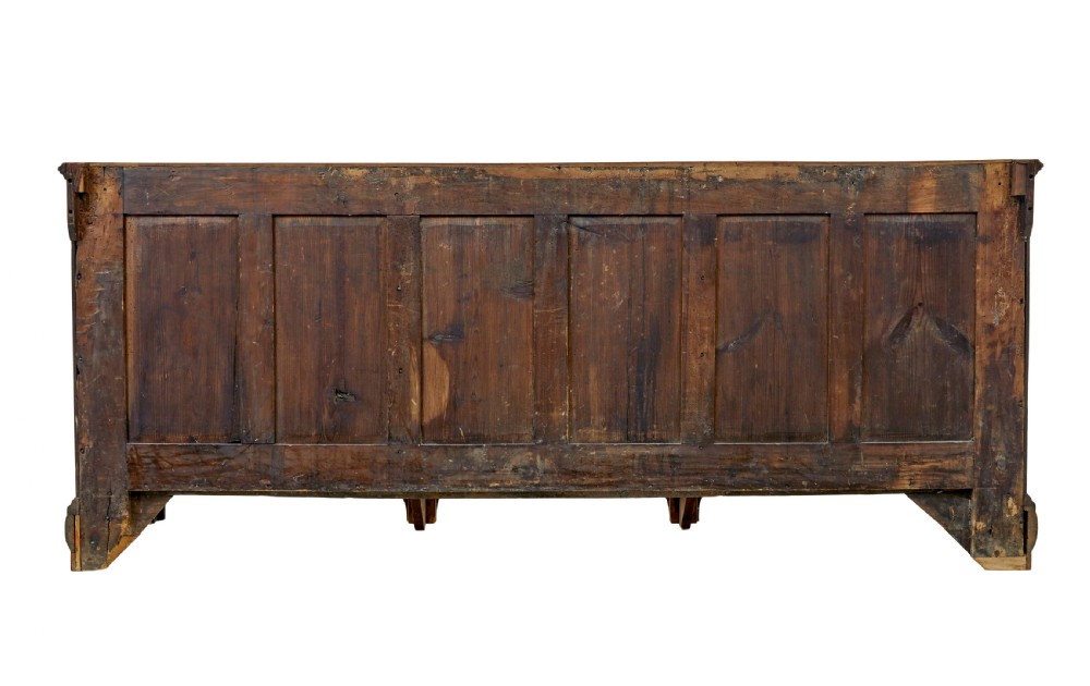 An 18th-century inlaid oak Lancashire dresser base featuring six drawers, a central two-door fielded panel cupboard, brass handles, and ogee bracket feet. View VII