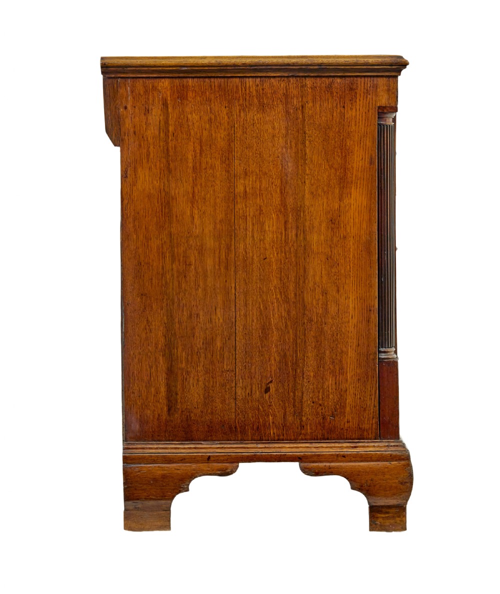 An 18th-century inlaid oak Lancashire dresser base featuring six drawers, a central two-door fielded panel cupboard, brass handles, and ogee bracket feet. View VIII