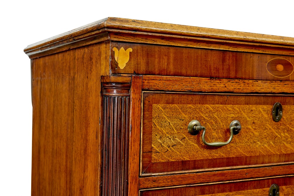 An 18th-century inlaid oak Lancashire dresser base featuring six drawers, a central two-door fielded panel cupboard, brass handles, and ogee bracket feet. View IX