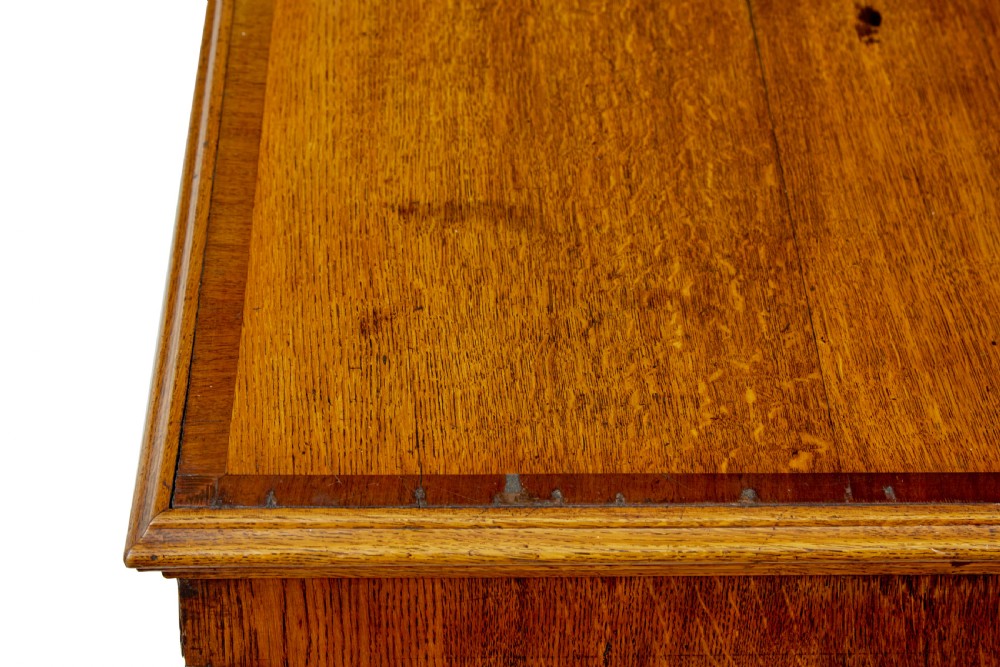 An 18th-century inlaid oak Lancashire dresser base featuring six drawers, a central two-door fielded panel cupboard, brass handles, and ogee bracket feet. View XIII