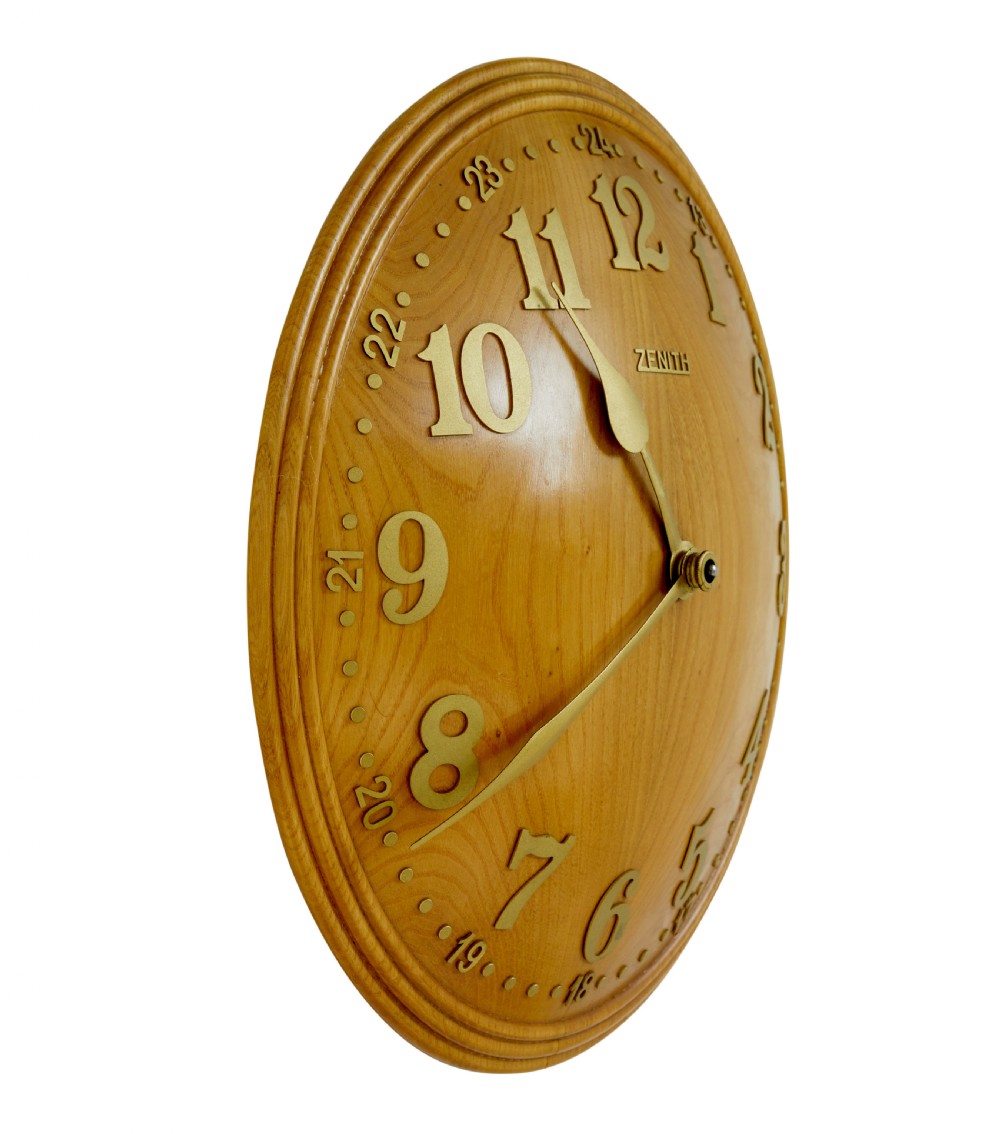 A circular Art Deco wall clock crafted from warm brown elm wood with applied brass numerals and hands. View IV