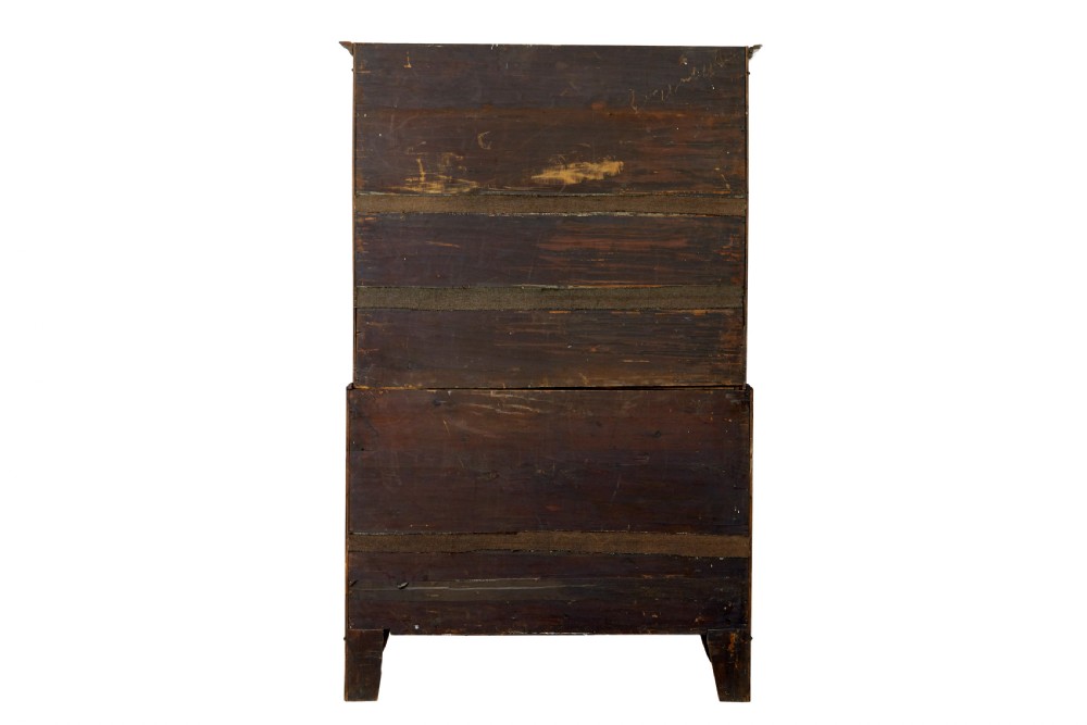 A two-section Late Georgian walnut chest on chest featuring figured timber veneers, brass drop handles, and bracket feet. View VI