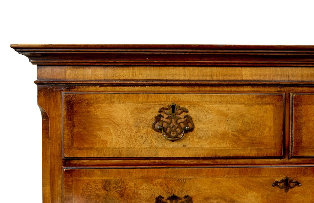 A two-section Late Georgian walnut chest on chest featuring figured timber veneers, brass drop handles, and bracket feet. View VIII