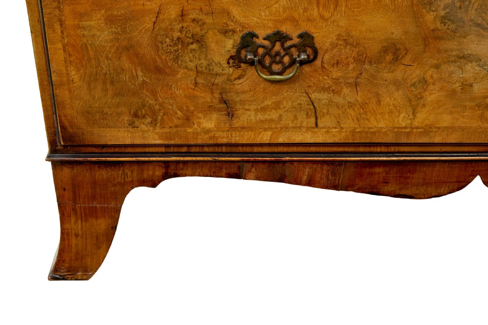 A two-section Late Georgian walnut chest on chest featuring figured timber veneers, brass drop handles, and bracket feet. View IX