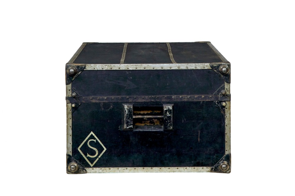 An open early 20th-century vertical steamer chest featuring a clothes hanging compartment with straps on the left and a column of six wooden drawers with recessed brass handles on the right. View IX