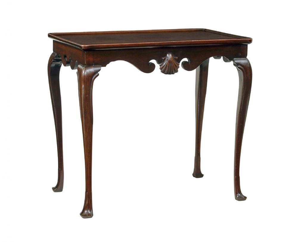 A dark mahogany Georgian-style silver table featuring cabriole legs with pad feet, a tray top edge, and a shell carved motif on the apron.