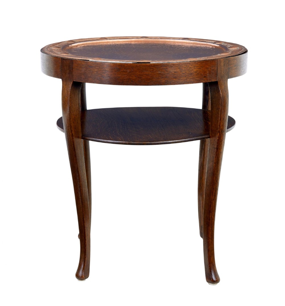 A late 19th-century Arts and Crafts circular oak occasional table featuring a central inset hammered copper tray top and a lower circular tier. View III
