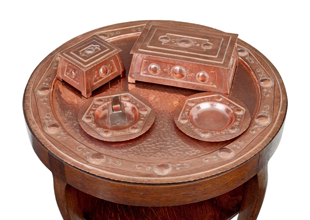 A late 19th-century Arts and Crafts circular oak occasional table featuring a central inset hammered copper tray top and a lower circular tier. View IV