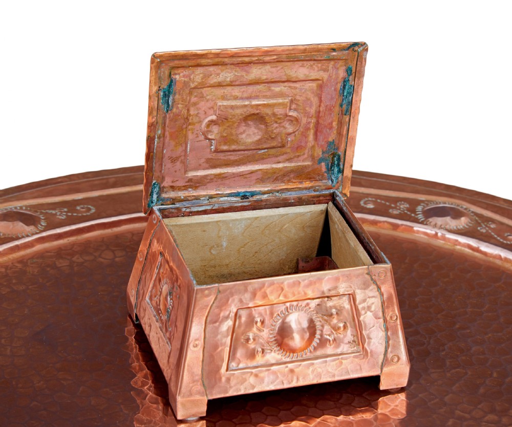 A late 19th-century Arts and Crafts circular oak occasional table featuring a central inset hammered copper tray top and a lower circular tier. View IX
