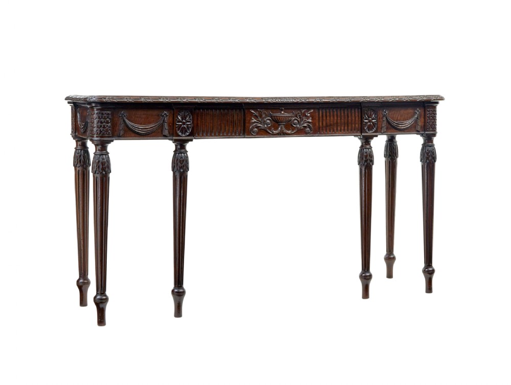 A 19th-century dark mahogany console table featuring a carved central urn, drapery swags, and six slender fluted legs.