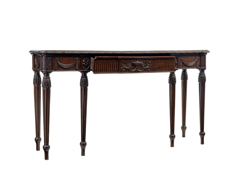 A 19th-century dark mahogany console table featuring a carved central urn, drapery swags, and six slender fluted legs. View II