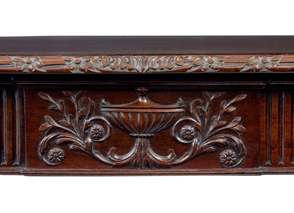 A 19th-century dark mahogany console table featuring a carved central urn, drapery swags, and six slender fluted legs. View VIII