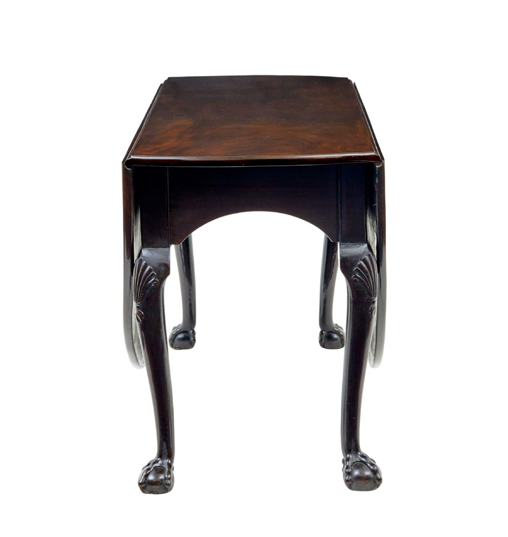 An eighteenth-century dark mahogany oval drop-leaf dining table featuring cabriole legs with carved knees and claw-and-ball feet. View VI
