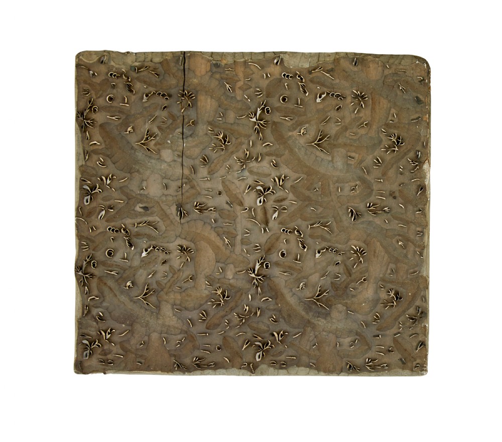 A collection of ten square and rectangular hand-carved wooden textile printing blocks featuring intricate brass wire and pin patterns. View II